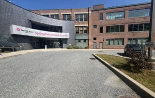 A photo of the entrance to a health center with a sign that reads Springfield Health Center