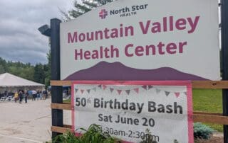Mountain Valley Health Center sign with 50th Birthday Bash banner below