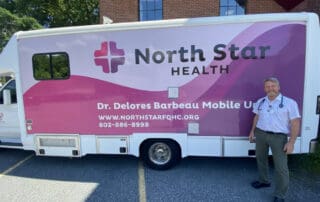 Will Hoser PA-C in front of the North Star Mobile Health Unit